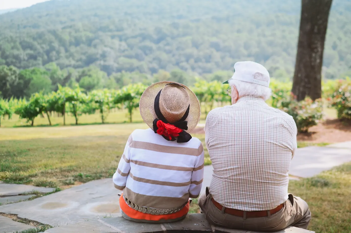 Two people sitting side by side looking out over a valley