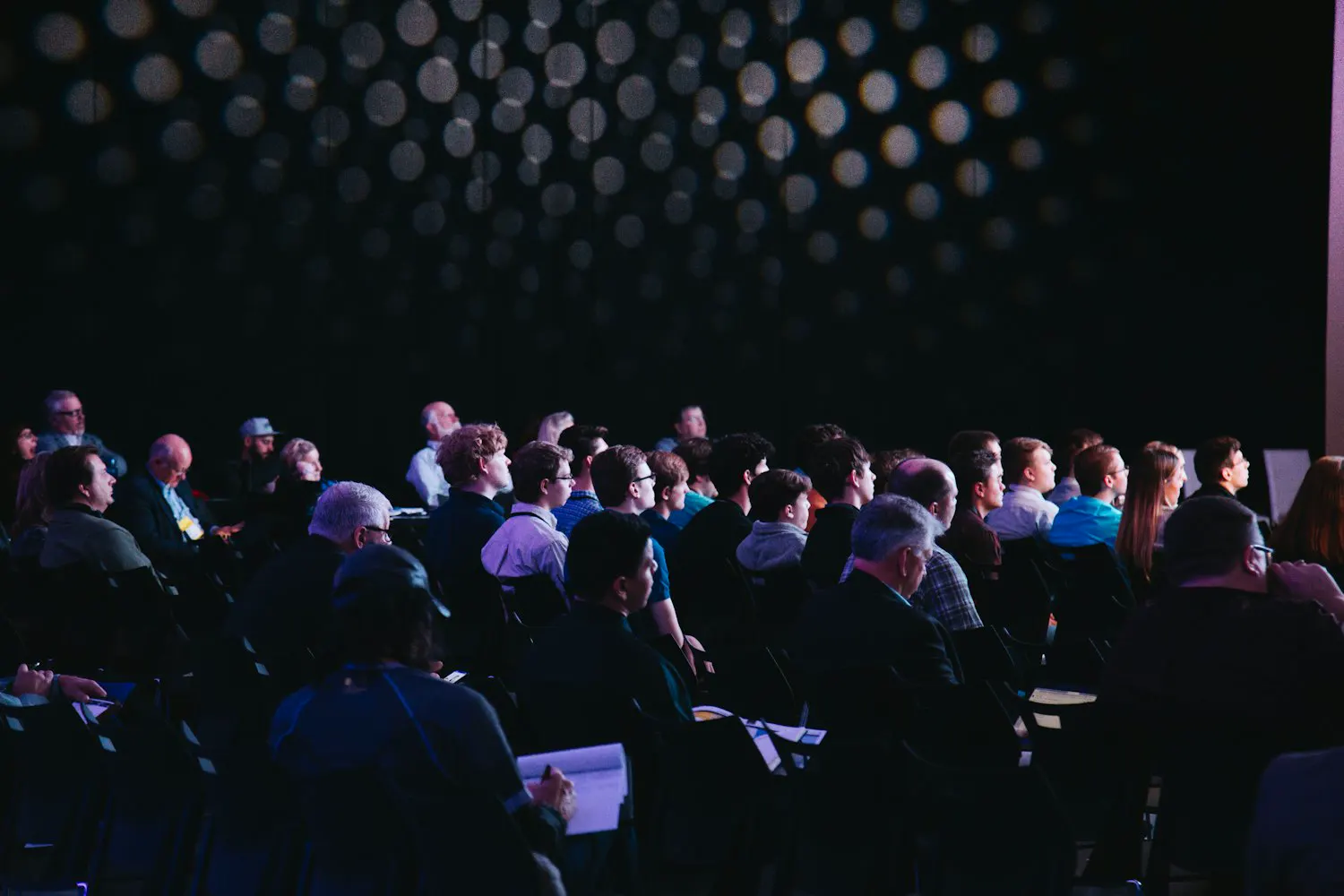 A full room of attendees at a live GET REAL seminar