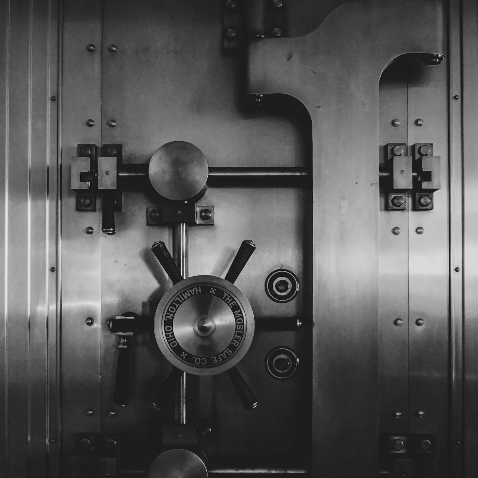 The mechanism of a heavy steel vault door, bolt work and dial